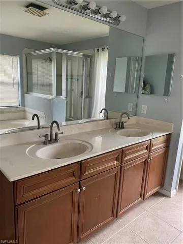 Dual vanity with integrated sinks, stone-finish countertop, and brushed nickel faucets