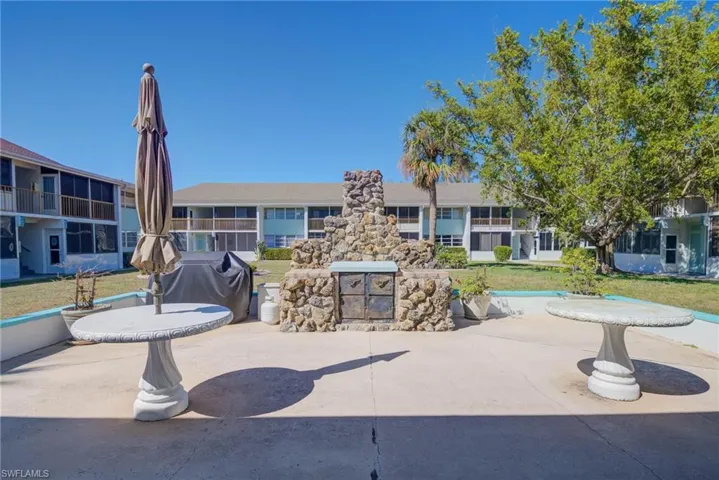 View of home's community with a patio area and a lawn