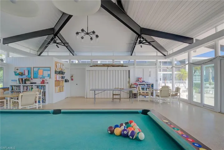 Rec room featuring lofted ceiling with beams, ceiling fan, and billiards