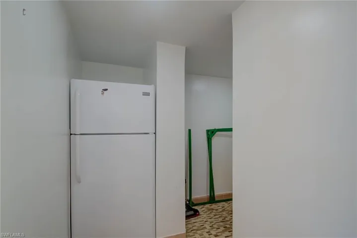 Kitchen with freestanding refrigerator