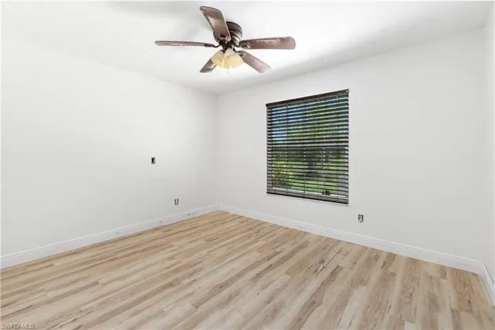 Spare room with light wood-type flooring and ceiling fan