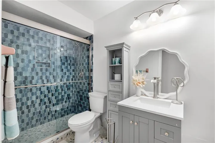Bathroom with a stall shower and vanity