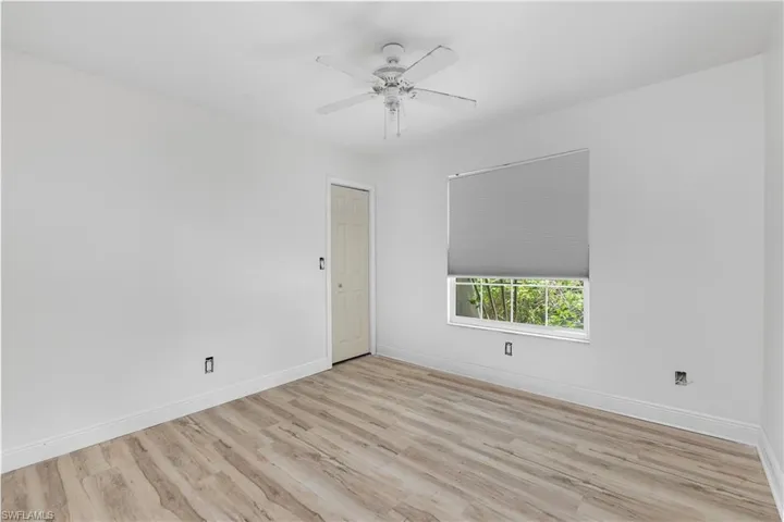 Empty room with light wood-type flooring and a ceiling fan