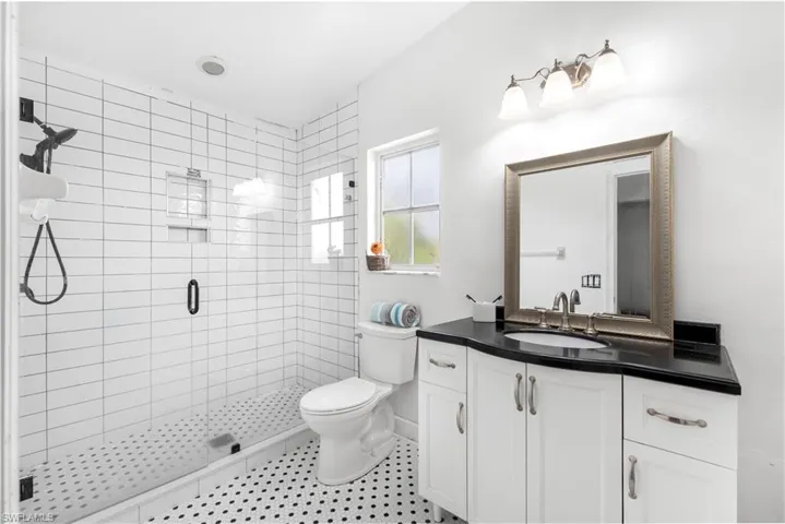 Full bath featuring a shower stall and vanity