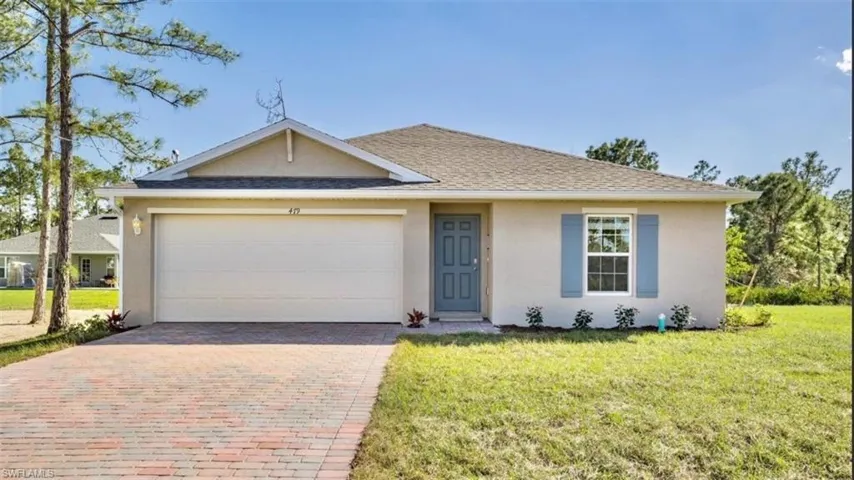 Model Home - Ranch-style home with stucco siding, decorative driveway, a front lawn, and an attached garage