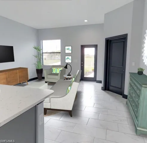 Open-concept living area featuring light-toned tile flooring, recessed lighting, and a kitchen island with a light-colored countertop