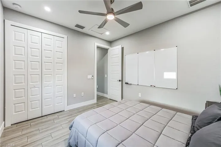 Interior room featuring wood-finish flooring, recessed lighting, and a ceiling fan