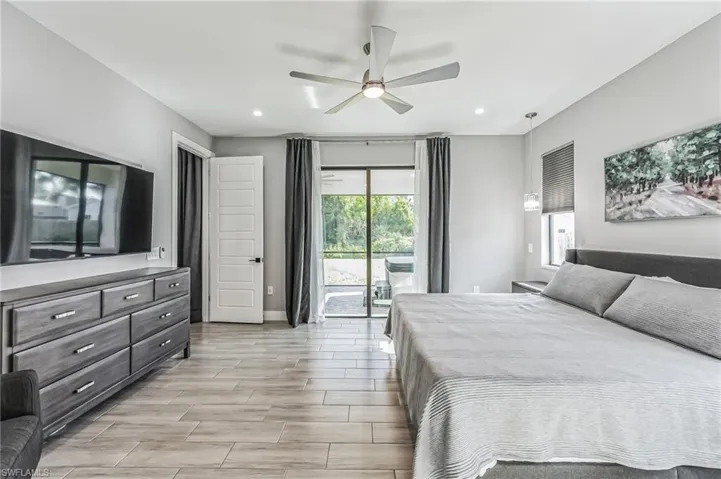 Spacious room featuring light wood-finish plank flooring and recessed lighting