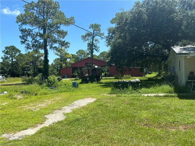View of green lawn with a pole building