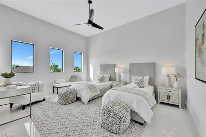 Bedroom with multiple windows and ceiling fan
