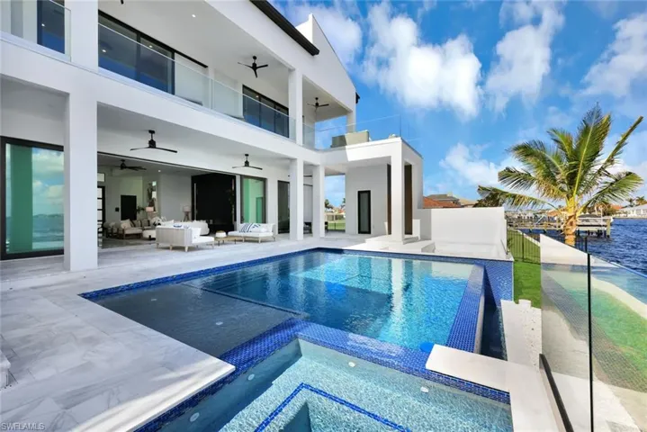View of swimming pool with ceiling fan, an outdoor hangout area, an in ground hot tub, and a patio