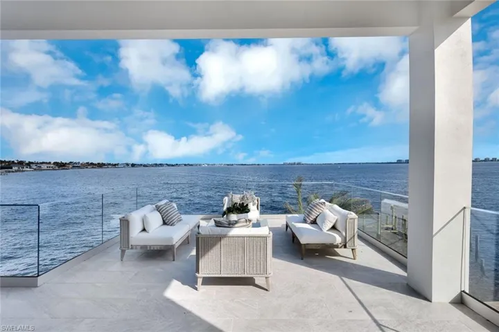 View of patio / terrace with an outdoor living space, a water view, and a balcony