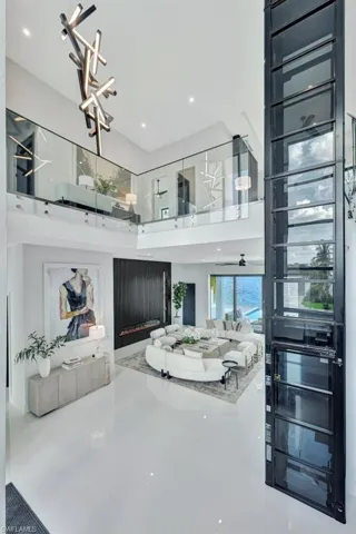 Living room featuring a high ceiling and a chandelier