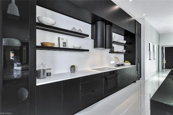 Kitchen featuring black appliances and exhaust hood