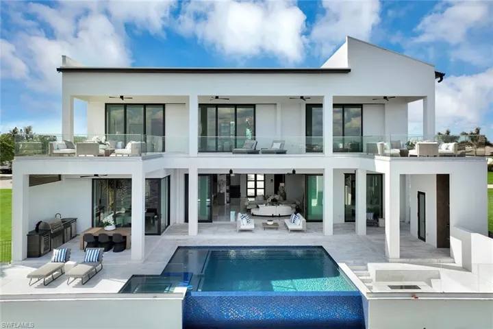 Rear view of property with an outdoor kitchen, an outdoor hangout area, ceiling fan, a balcony, and a patio