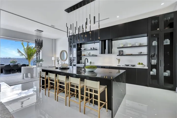 Kitchen with a kitchen island with sink and light tile patterned flooring