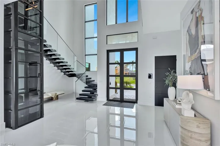 Entryway featuring french doors and a high ceiling