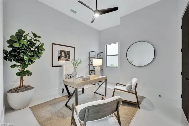 Office space with ceiling fan and lofted ceiling