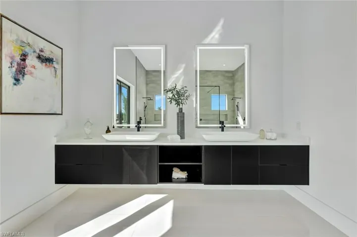 Bathroom with tile patterned floors, vanity, and tiled shower