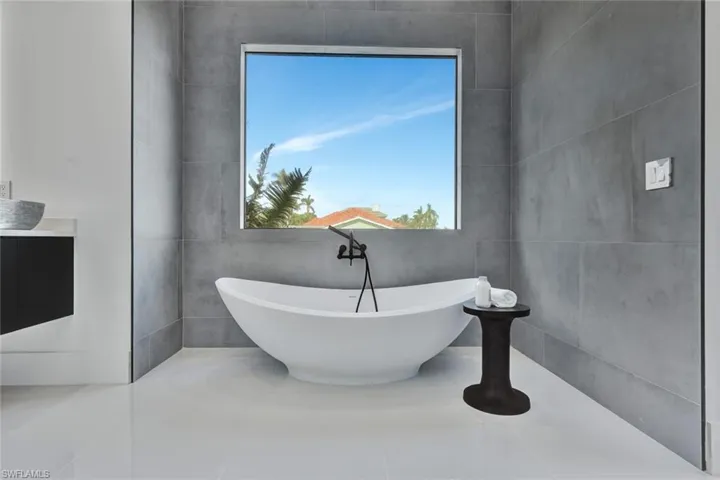 Bathroom with a washtub and vanity