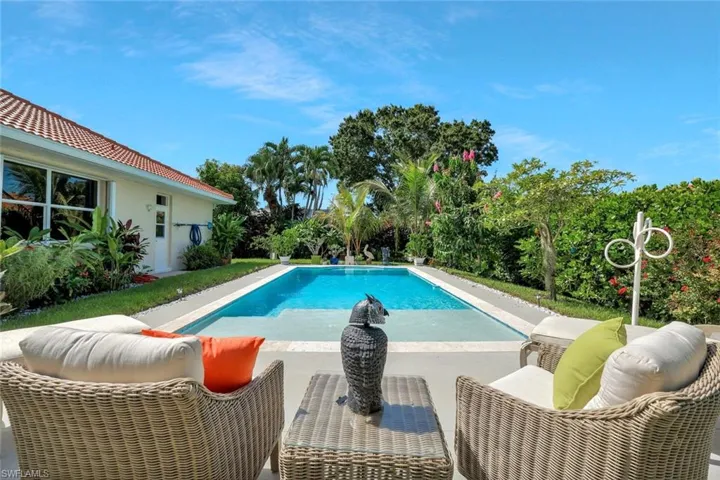 Outdoor pool with a patio and an outdoor living space