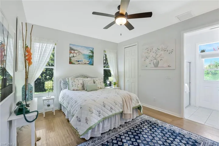 Bedroom featuring light wood-type flooring, a closet, and a ceiling fan