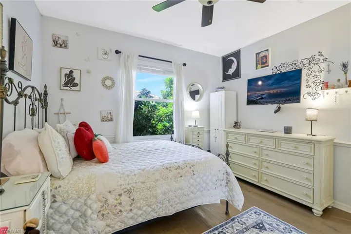 Bedroom with dark wood-style floors and a ceiling fan