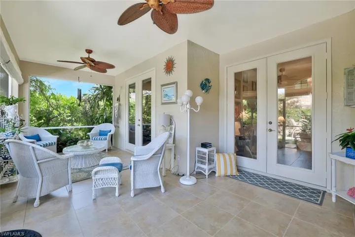 Sunroom / solarium featuring french doors