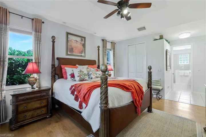 Bedroom with wood finished floors, a closet, and ceiling fan