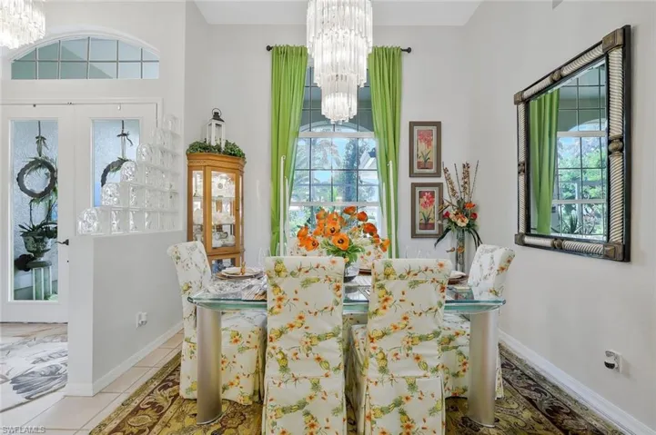 Dining room featuring a chandelier and light tile patterned flooring