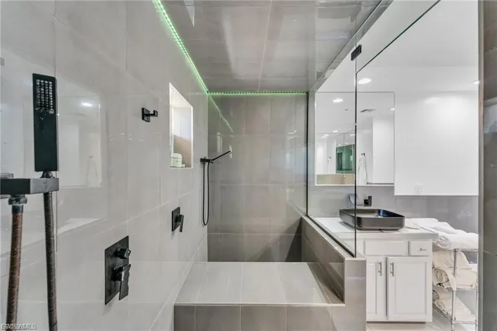 Bathroom featuring vanity, walk in shower, and recessed lighting