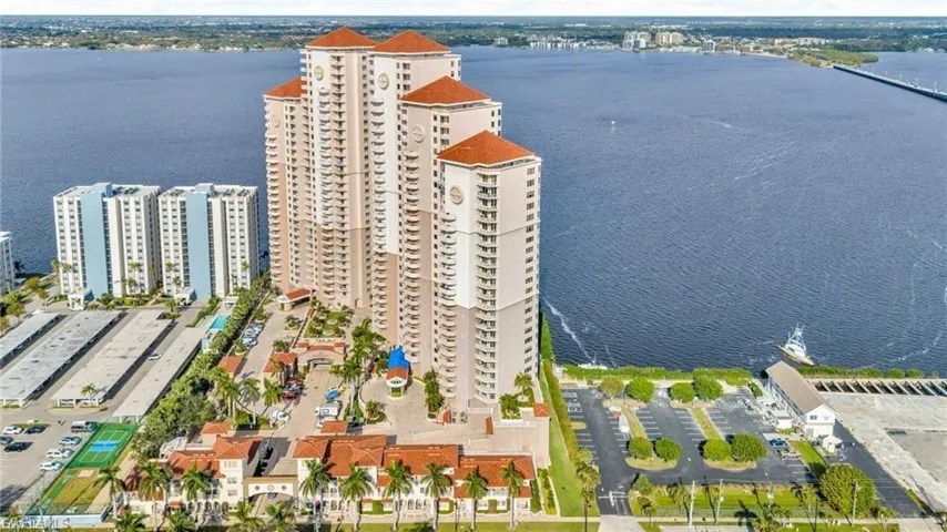 Drone / aerial view of a large body of water and apartment complex