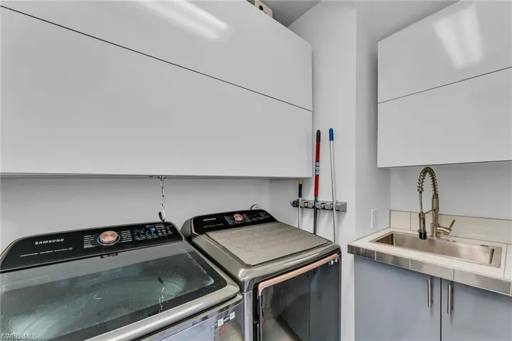 Laundry area featuring cabinet space and independent washer and dryer