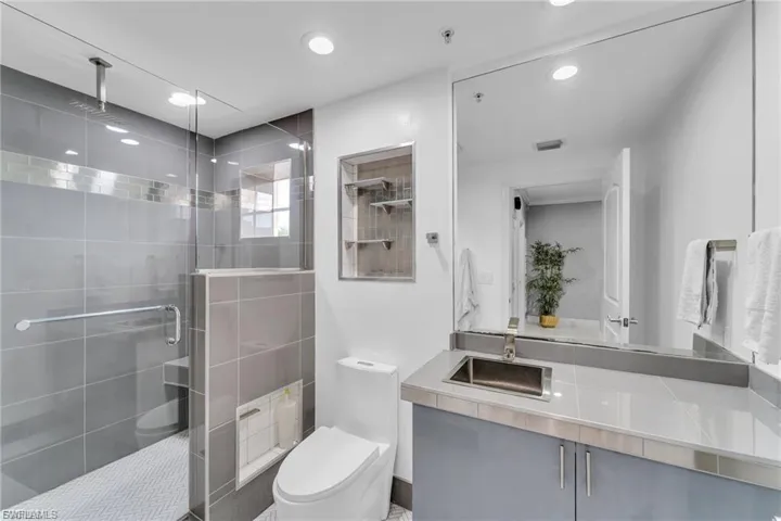 Full bathroom featuring vanity, a shower stall, and recessed lighting