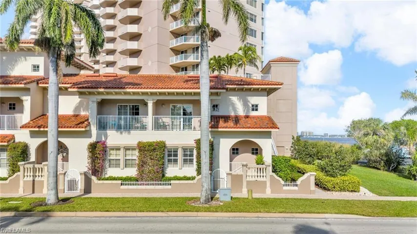 View of apartment building / complex with a fenced front yard