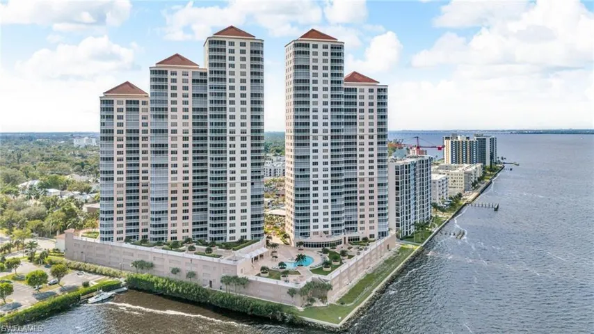 View of property featuring a water view and a city view