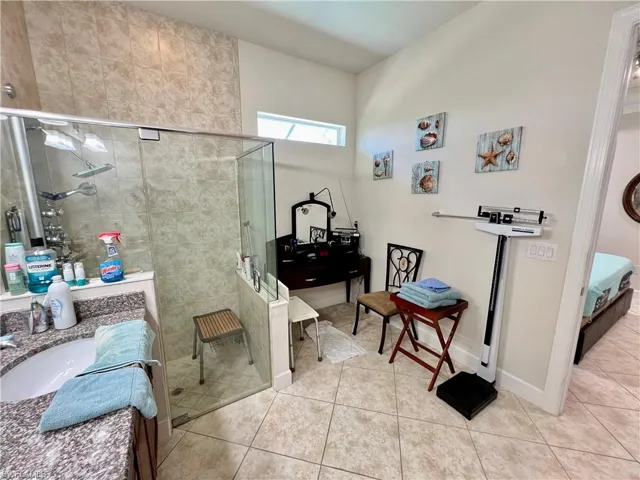 Master bathroom with granite counters, dual sinks, oversized walk in shower and a Woodbridge one piece smart toilet