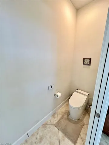 Master bathroom with granite counters, dual sinks, oversized walk in shower and a Woodbridge one piece smart toilet