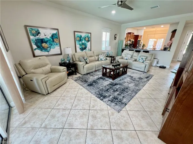 Living room featuring crown molding, recessed LED lighting and high end ceiling fan