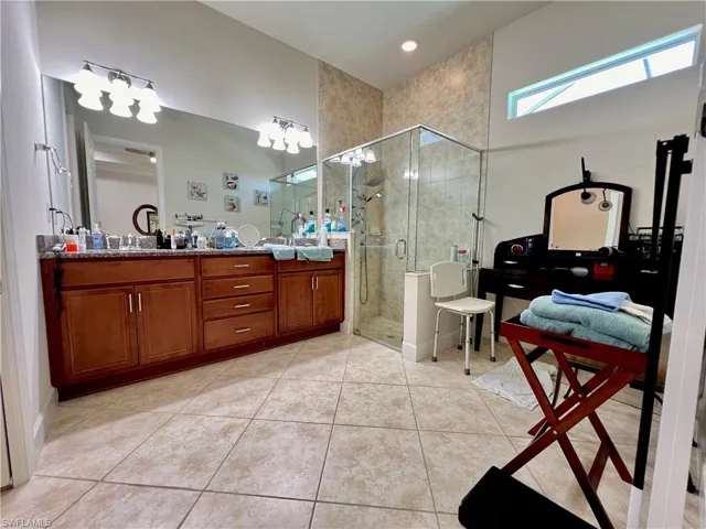 Master bathroom with granite counters, dual sinks, oversized walk in shower and a Woodbridge one piece smart toilet