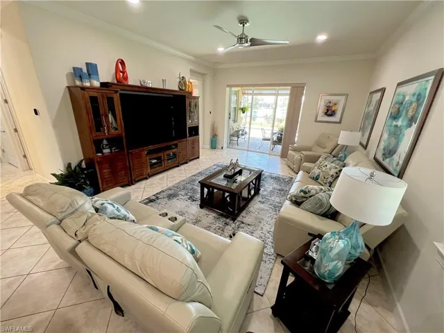Living room featuring crown molding, recessed LED lighting and high end ceiling fan