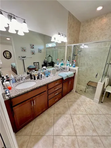 Bathroom with double sink vanity and tile floors