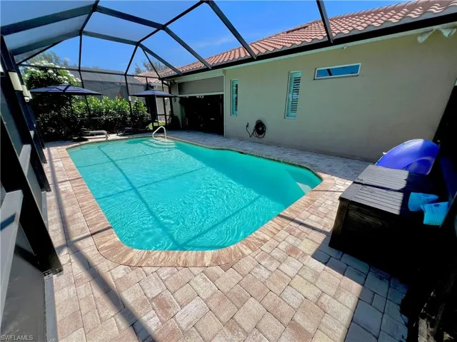 Screened lanai with a large electric heated pool, automated LED pool lighting and brick pavers
