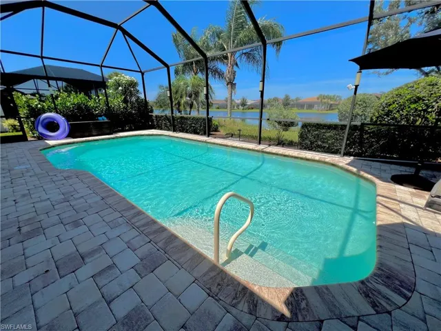 Screened lanai with a large electric heated pool, automated LED pool lighting and brick pavers