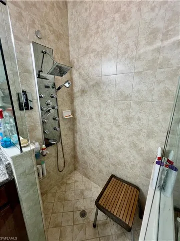 Master bathroom with granite counters, dual sinks, oversized walk in shower and a Woodbridge one piece smart toilet