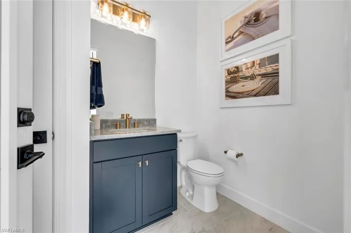 Bathroom featuring vanity, toilet, and tile patterned floors