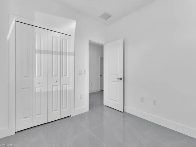 Unfurnished bedroom with tile patterned floors and a closet