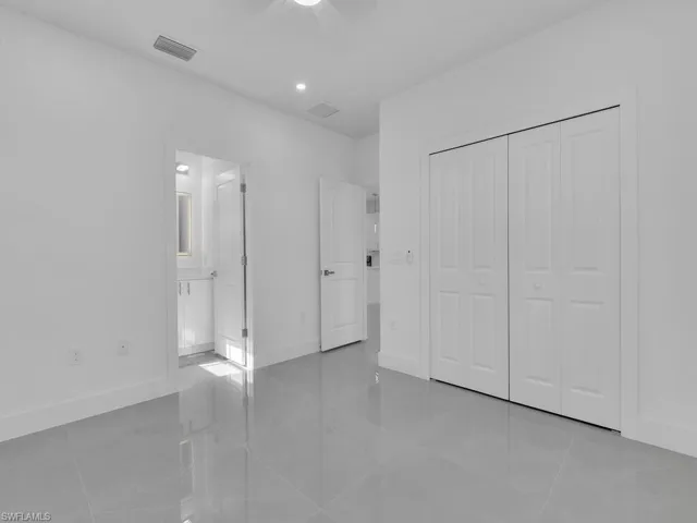 Unfurnished bedroom featuring light tile patterned floors, a closet, and recessed lighting