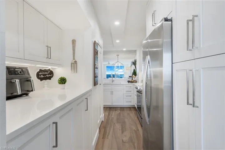 Coffee bar on left with washer and dryer hidden in lower cabinet