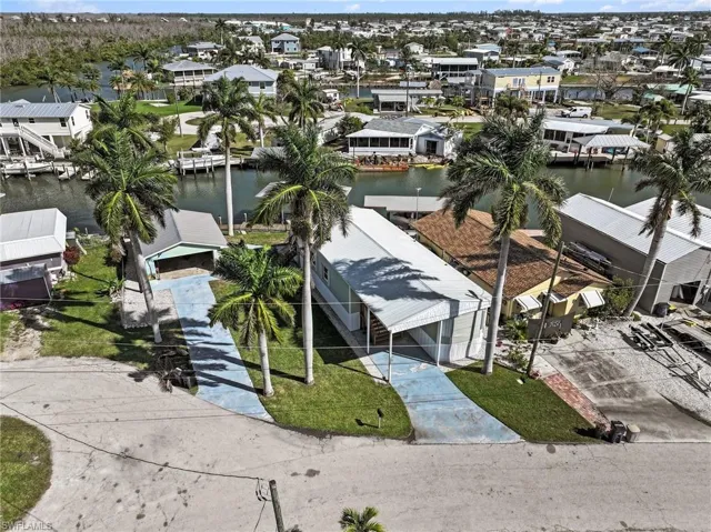 Aerial perspective of suburban area featuring a nearby body of water